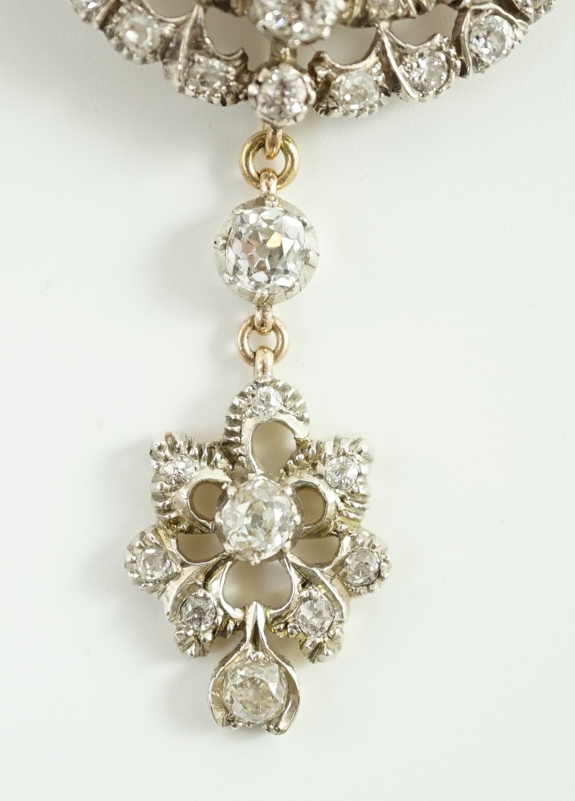 A Victorian gold, silver and graduated diamond cluster set target drop pendant brooch, retailed by Carlo & Arthur Giuliano